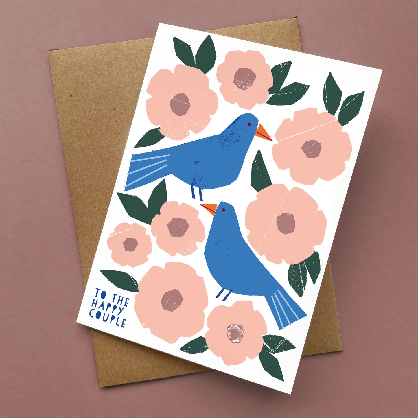 Greeting Card Happy Couple features two blue birds among pink flowers and green leaves, with brown kraft envelope