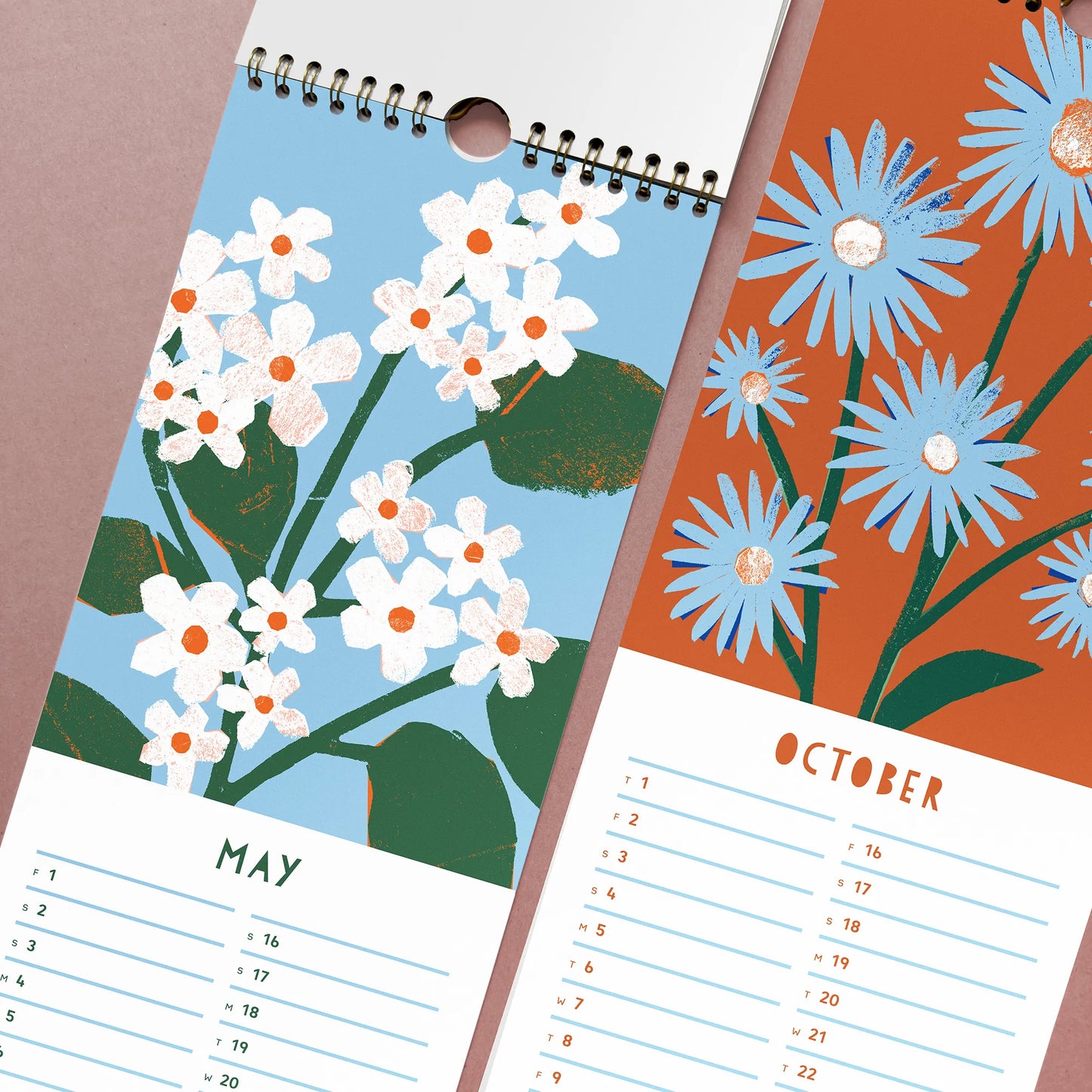 Close-up of May and October pages from the 2026 Kautzi calendar with Nova Scotia–inspired paper cut flowers