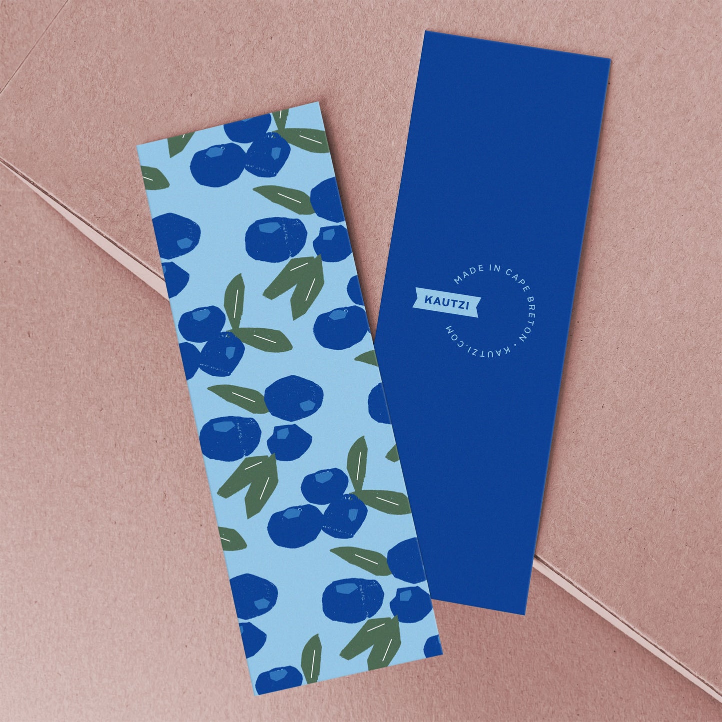 Bookmark Blueberries features a vibrant pattern of blue berries and green leaves on light blue, with navy blue reverse side
