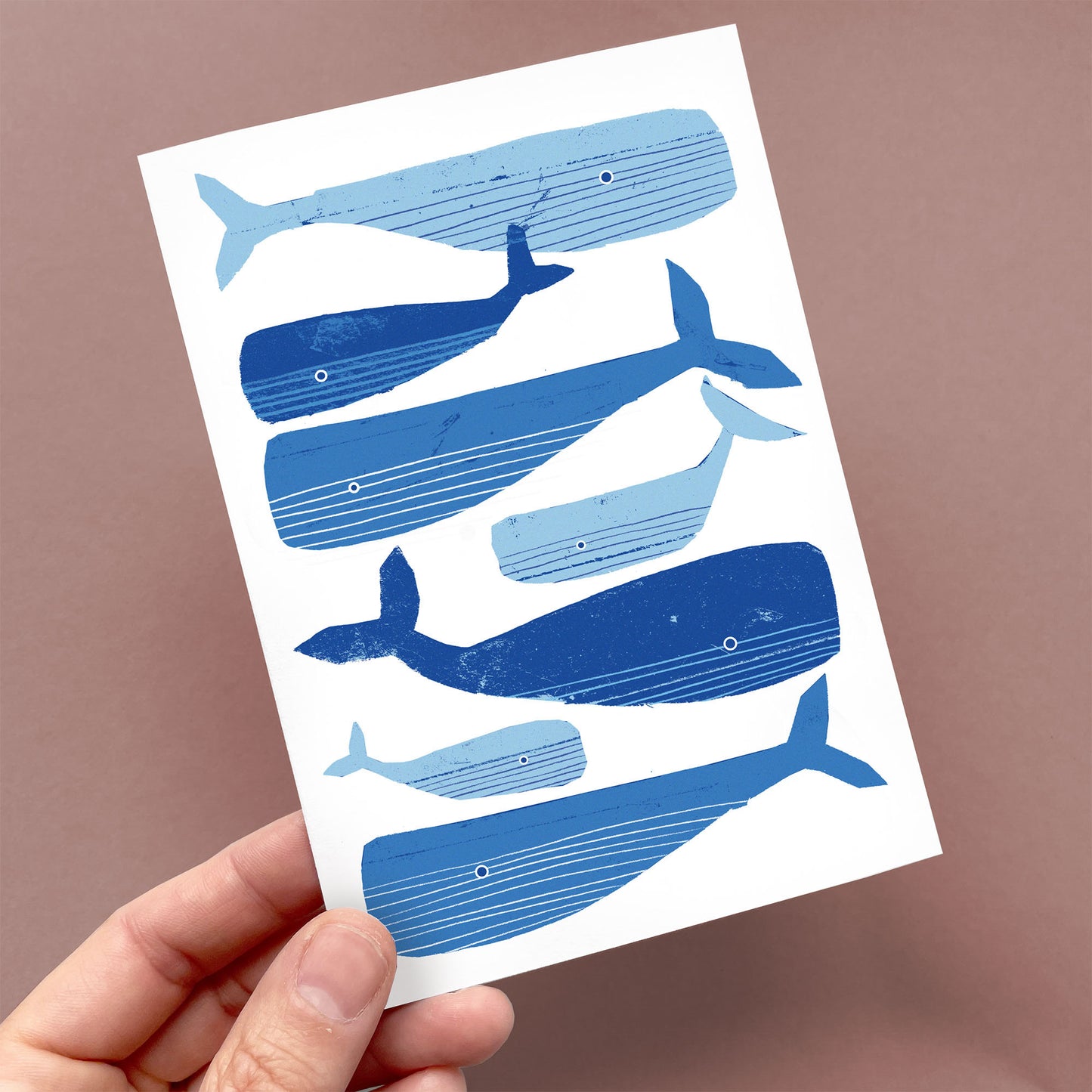Greeting Card Pod of Whales featuring six blue whales in varying shades swimming gracefully on white recycled paper. Maritime Cards by Kautzi