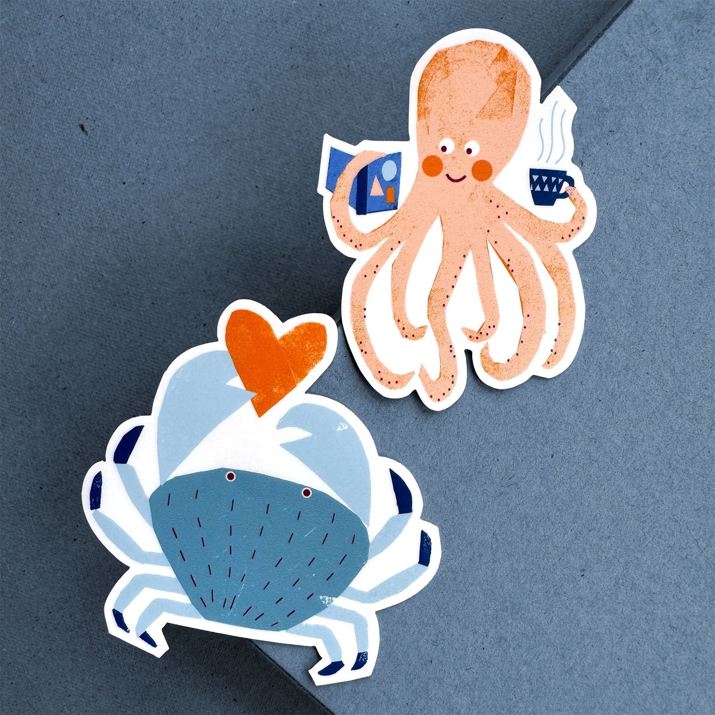 Sticker Octopus with peach-colored tentacles holding books, paired with blue crab featuring orange heart detail