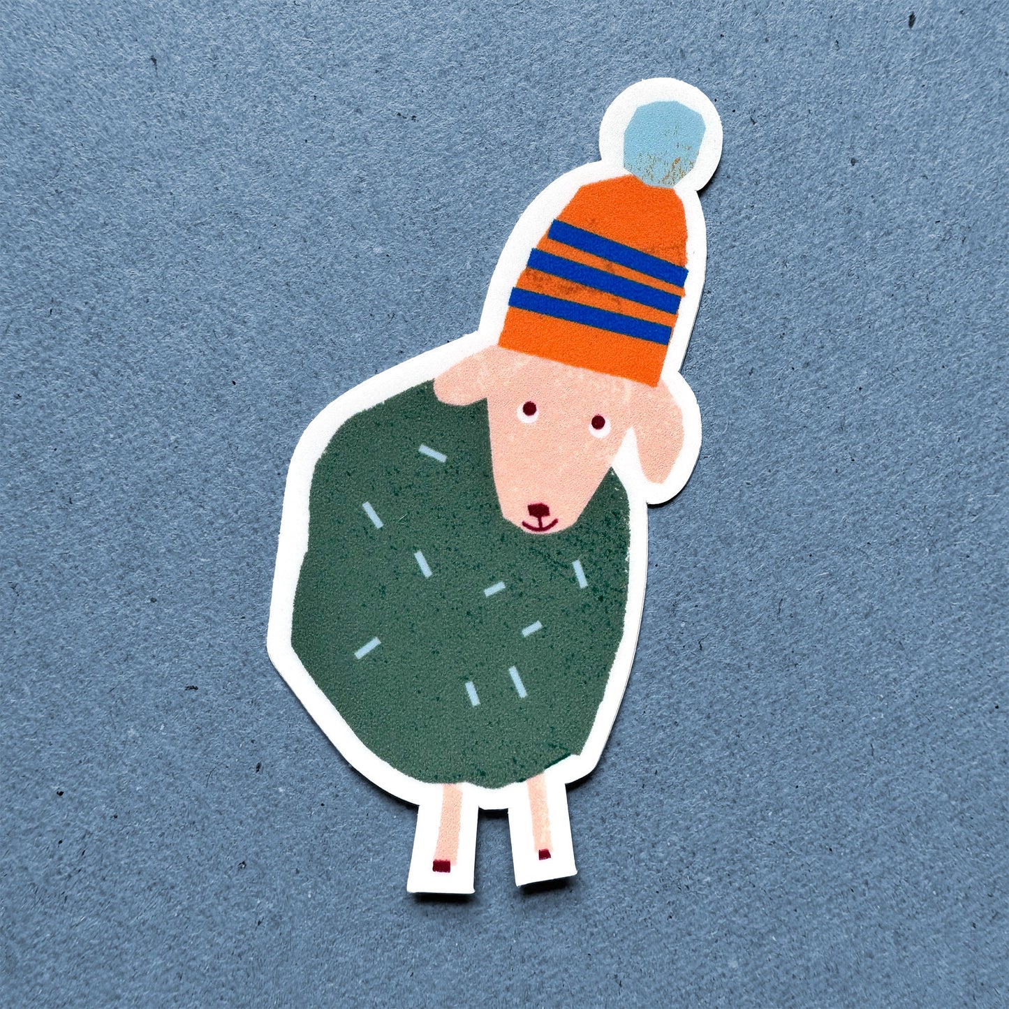 Sticker Sheep in cozy orange striped winter hat and green wool, cute illustration vinyl sticker