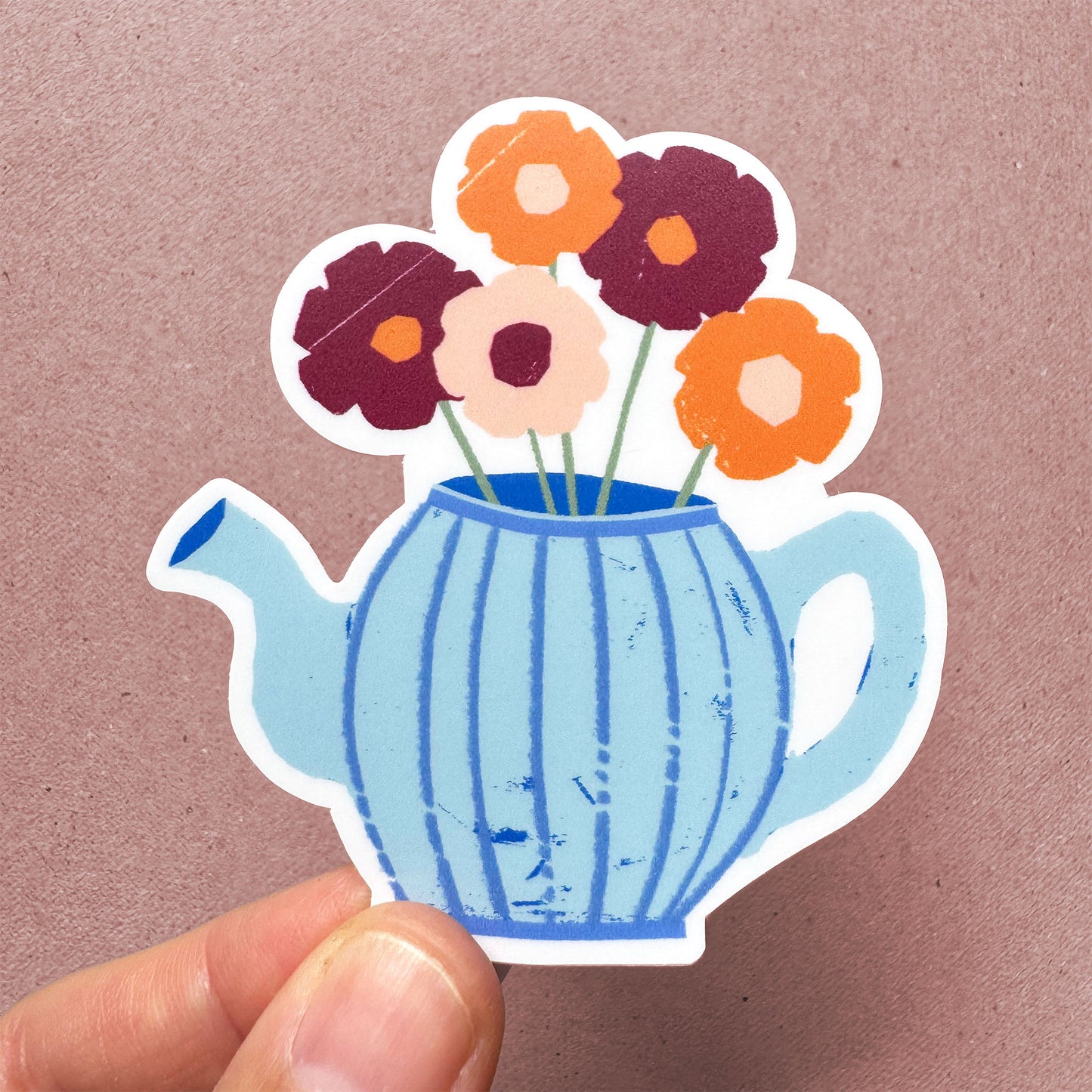 Teapot sticker with burgundy and orange flowers in a striped blue teapot vase