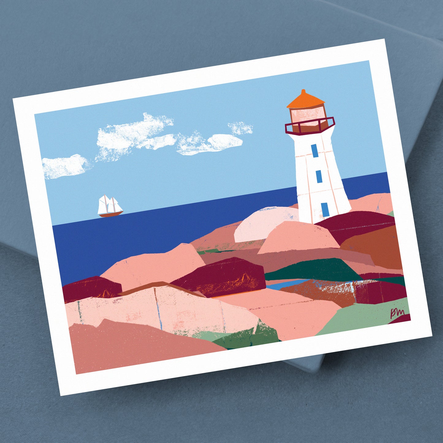 Kautzi art print of Peggy's Cove lighthouse, shown at an angle on a slate blue surface. Bold collage-style illustration of the iconic Nova Scotia, Canada landmark, featuring pink granite rocks, deep blue ocean, and sage green accents.