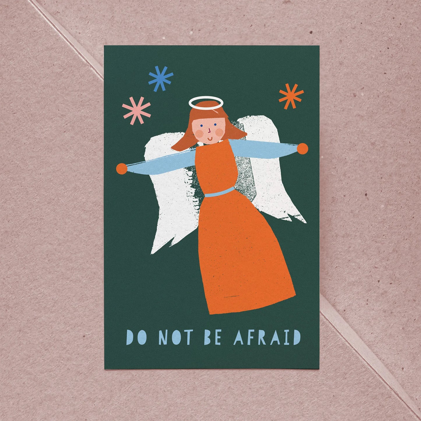 Christmas card Angel featuring a whimsical orange and blue angel illustration with "Do Not Be Afraid" text on dark green background.