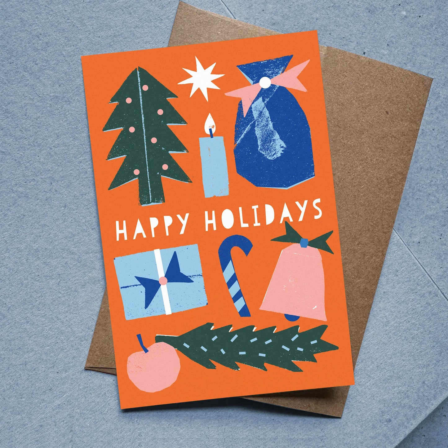 Flat Card – Happy Holidays with colorful holiday icons on orange background, kraft envelope included, designed by Kautzi.