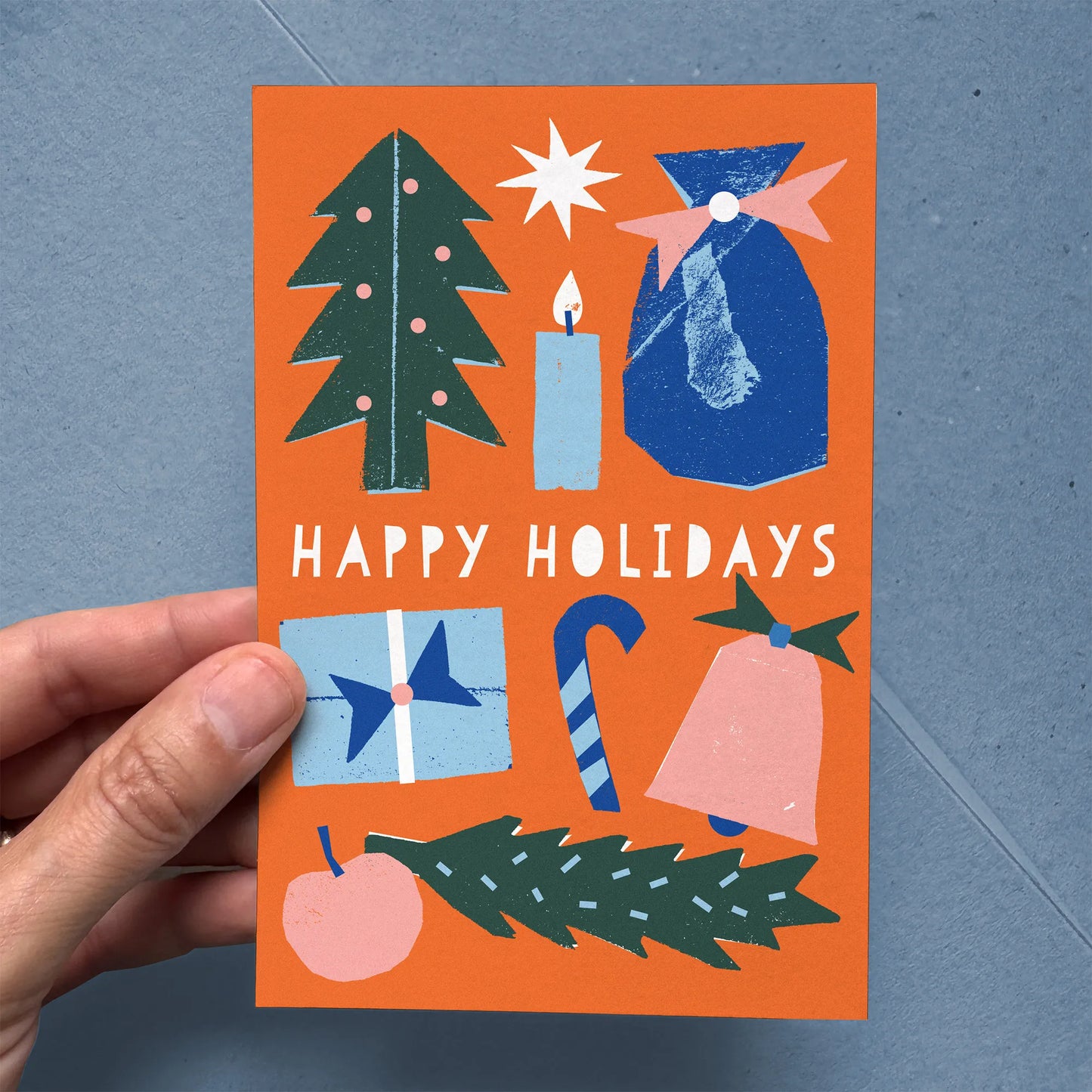 Flat Card – Happy Holidays with bold tree, candle, gift, candy cane, and festive motifs in bright colors on orange background.