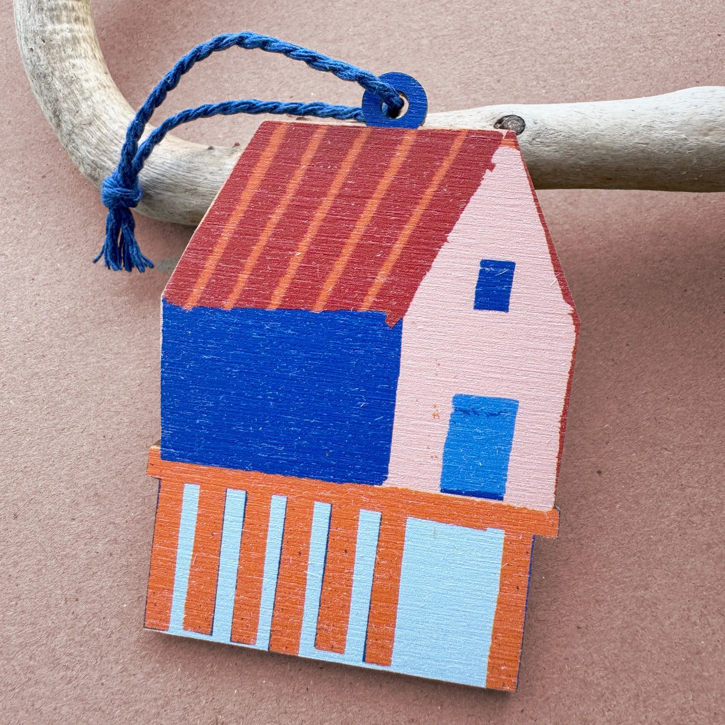 Colourful wooden fish shack ornament with a red roof and blue walls, designed by Kautzi in Cape Breton, Nova Scotia.