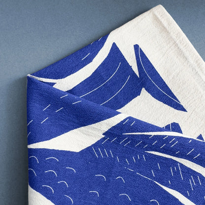 Close-up detail of the Into the Waves tea towel design by Kautzi, featuring bold blue and white coastal-inspired patterns screen-printed on flour sack cotton.