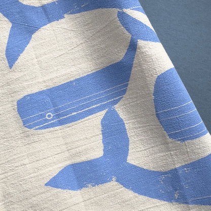 Close-up of the Singing Whales tea towel by Kautzi, featuring a stylized whale illustration in soft blue, screen-printed on flour sack cotton.