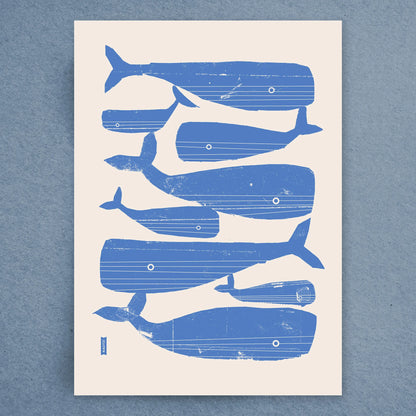 Flat lay of the Singing Whales tea towel by Kautzi, showcasing a minimalist whale pattern in blue, screen-printed on soft flour sack cotton.