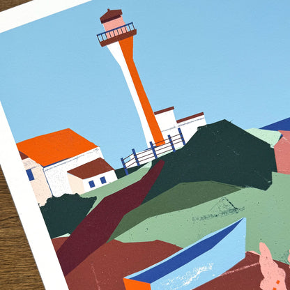 Close-up detail of Kautzi's Cape Forchu lighthouse art print, showing the bold collage-style illustration of the distinctive orange-and-white tower, keeper's buildings, and layered green and burgundy coastal rocks. Printed on archival cotton paper in Cape Breton, Nova Scotia, Canada.