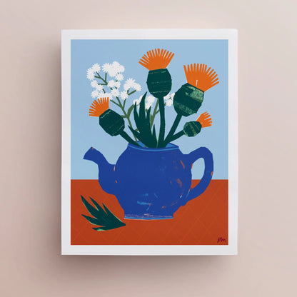 Kautzi Thistles & Teapot art print – 11" × 14" still life illustration featuring orange thistles and white flowers in a blue teapot on a terracotta table, designed and printed in Cape Breton, Nova Scotia.