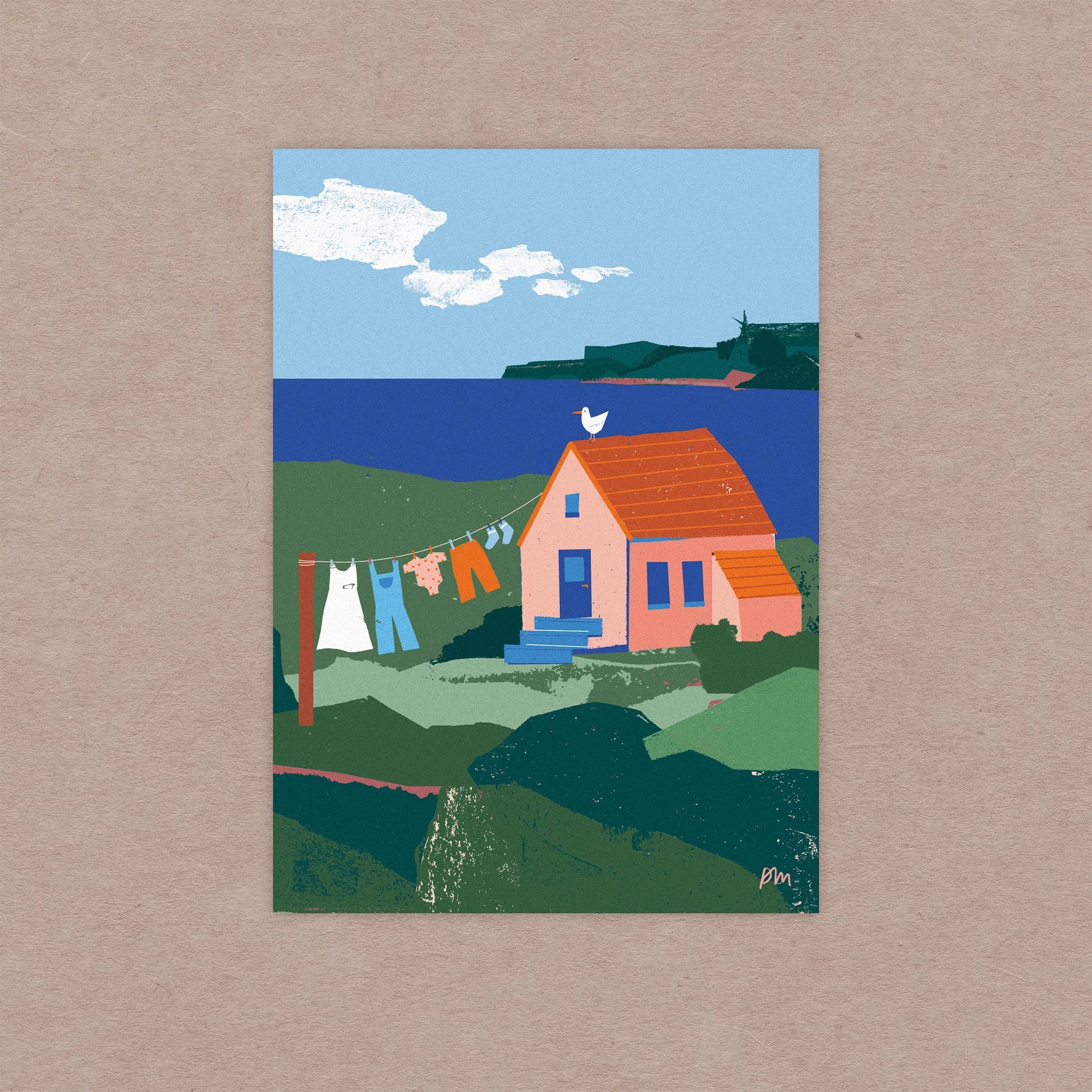 Kautzi Illustrations 5x7 Clothesline mini art print shown on a neutral kraft background, featuring a small coastal house, clothesline, and blue ocean inspired by Cape Breton, Nova Scotia.