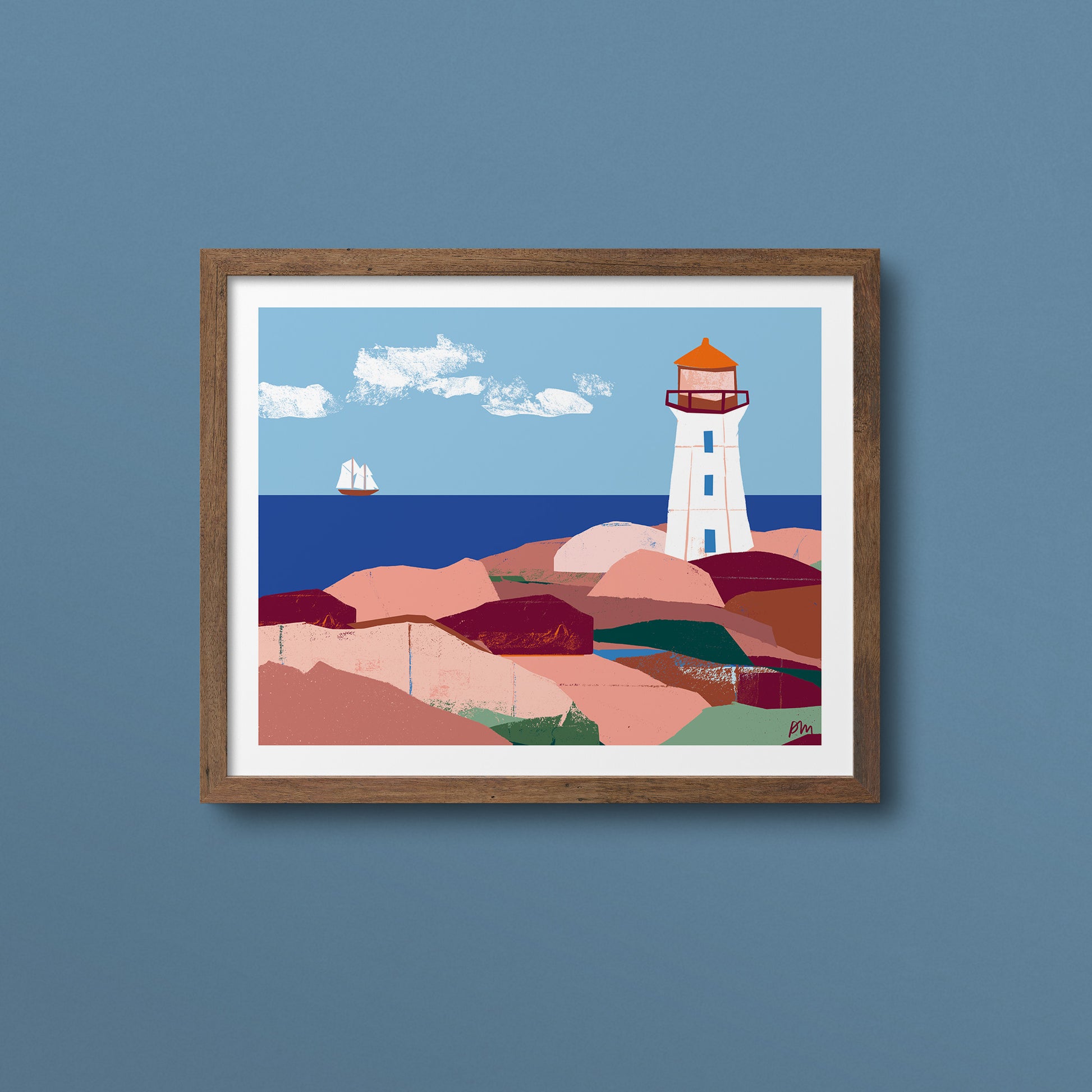 Kautzi's Peggy's Cove lighthouse landscape art print displayed in a walnut wood frame with white mat, mounted on a muted blue wall. Bold illustrated style capturing the iconic Nova Scotia landmark and coastline, with warm pink rocks, deep blue sea, and a schooner in the distance.