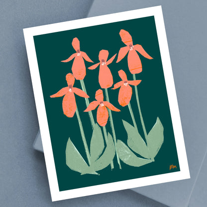Kautzi Illustrations 8×10 Pink Lady’s Slippers art print on a soft grey surface, featuring stylized coral-pink wildflowers and green leaves against a deep green background, inspired by Maritime flora.