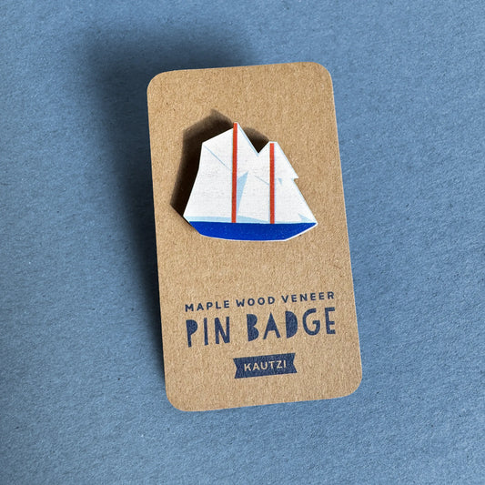 Kautzi maple wood veneer boat pin badge on kraft display backing, nautical design inspired by Nova Scotia’s iconic Bluenose schooner