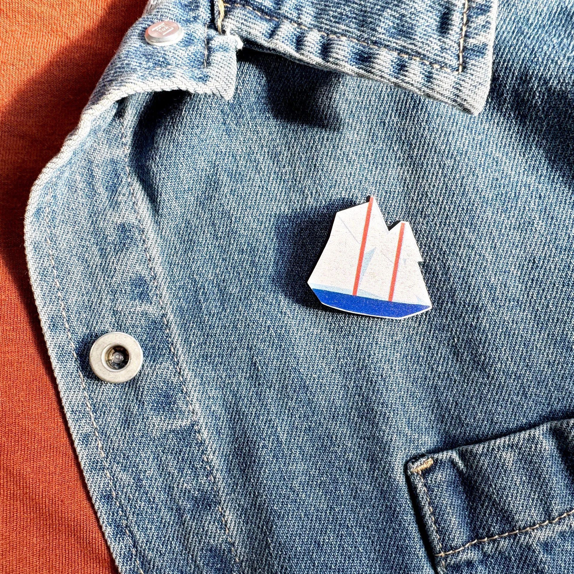 Kautzi maple wood veneer boat pin badge attached to denim jacket, maritime style accessory