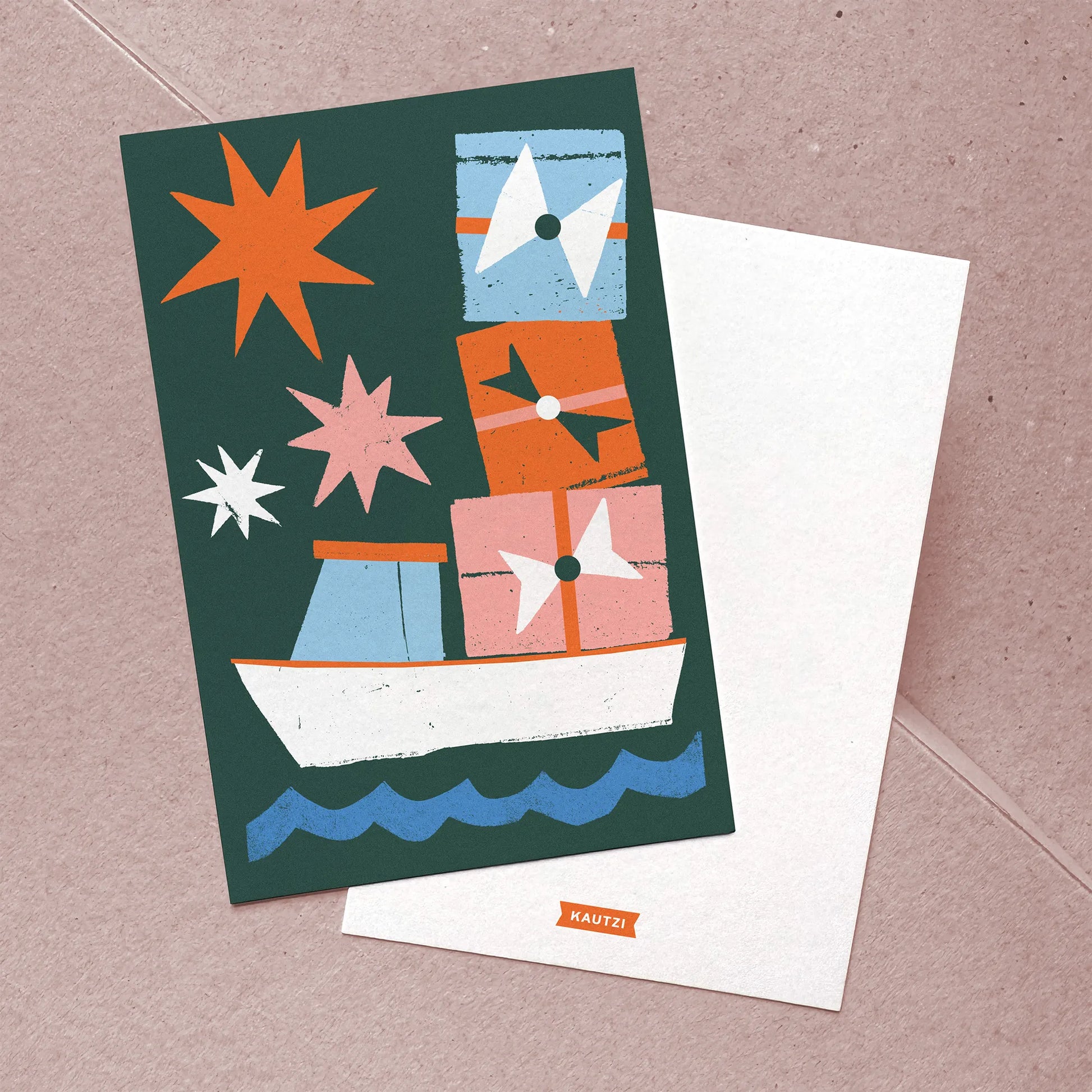 Flat lay of front and back of Kautzi’s "Christmas Cargo" card, with colourful lobster boat illustration on front and simple logo on the back.