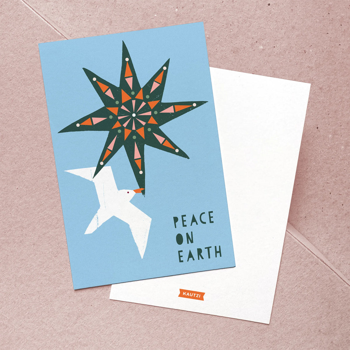 Front and back of the Kautzi Peace on Earth Christmas card featuring a bold geometric star and white seagull illustration in teal, orange, and sky blue; back shows the Kautzi logo printed on white. Designed and made in Canada, Maritime holiday stationery