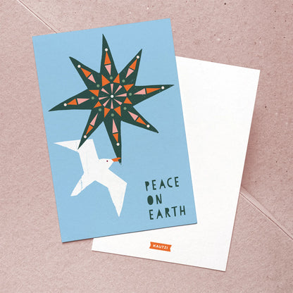 Front and back of the Kautzi Peace on Earth Christmas card featuring a bold geometric star and white seagull illustration in teal, orange, and sky blue; back shows the Kautzi logo printed on white. Designed and made in Canada, Maritime holiday stationery