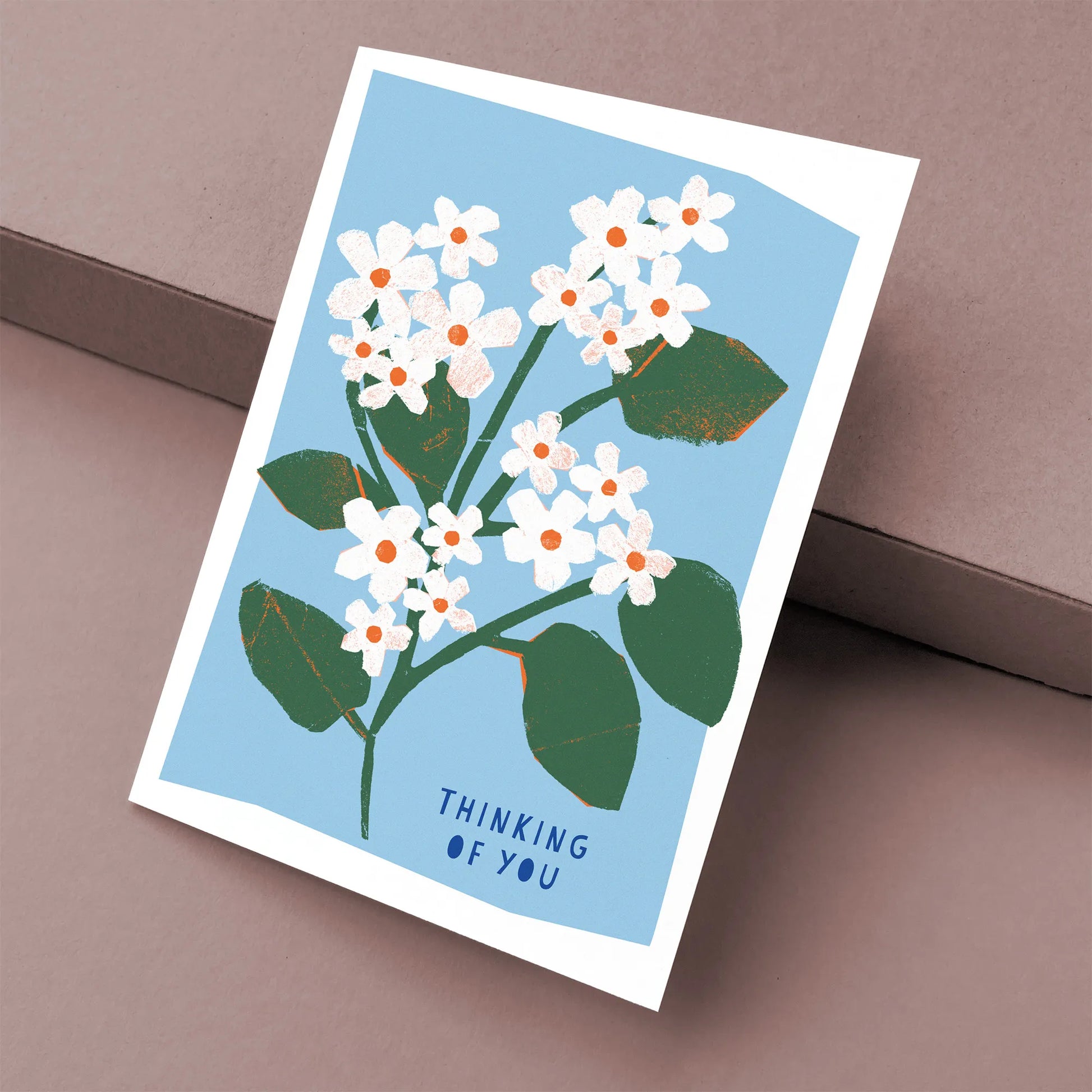 Kautzi thinking of you greeting card with white mayflower illustration on blue background, floral design inspired by Atlantic Canada, Cape Breton, Nova Scotia, Canada