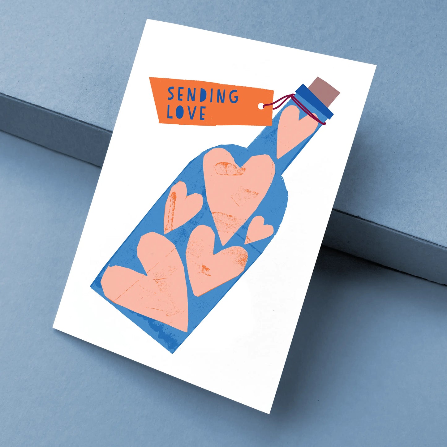 Kautzi Sending Love card at angle – Cape Breton papercut illustration.