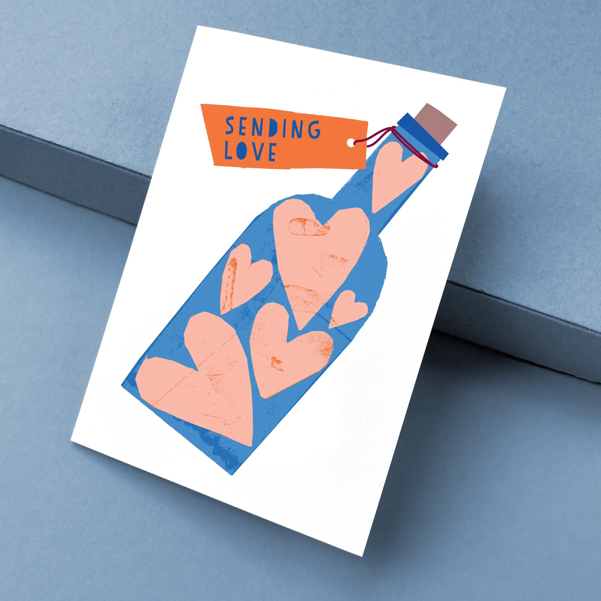 Kautzi Sending Love card at angle – Cape Breton papercut illustration.