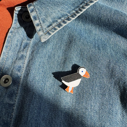 Kautzi maple wood veneer puffin pin badge attached to denim jacket, coastal wildlife accessory