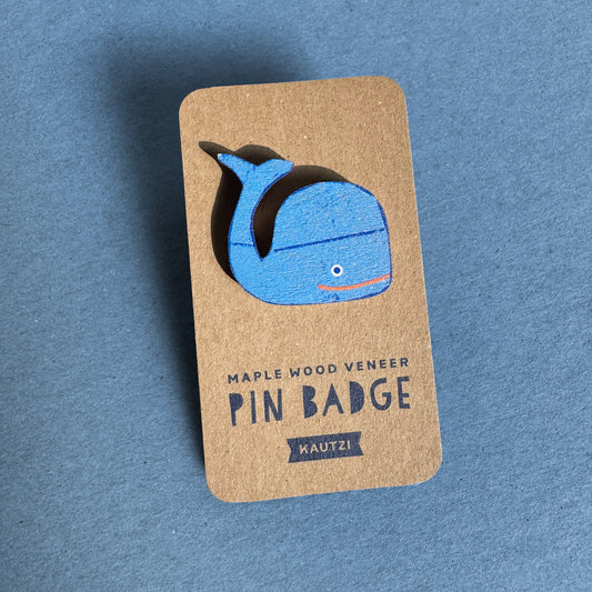 Kautzi maple wood veneer whale pin badge on kraft display backing, bright blue whale design inspired by the waters of Nova Scotia