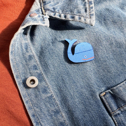Kautzi maple wood veneer whale pin badge attached to denim jacket, playful maritime accessory