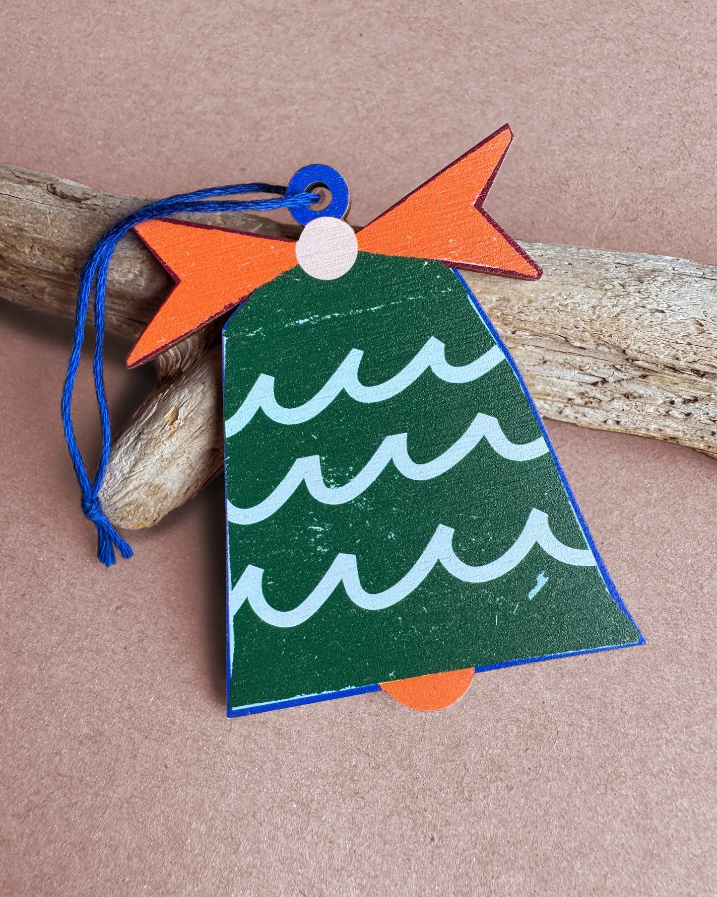 Kautzi green wooden bell ornament with wave pattern and orange bow, designed in Cape Breton, Nova Scotia.