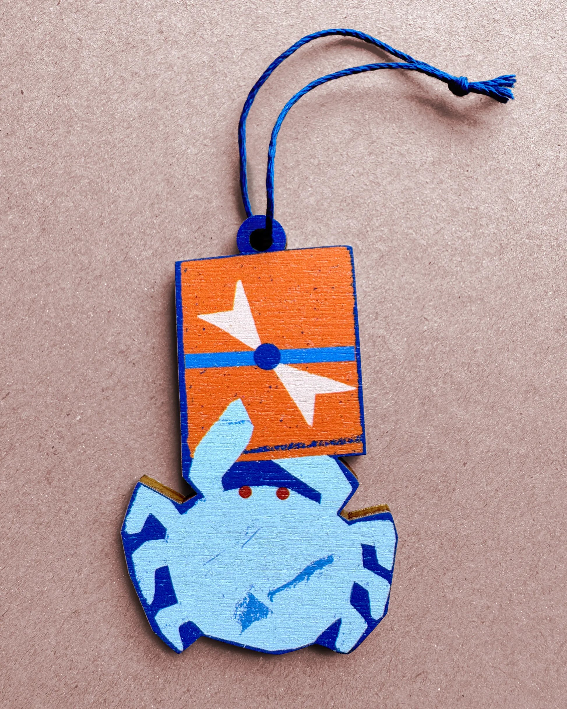 Flat lay of the Kautzi crab wooden ornament with gift box detail, designed in Cape Breton, Canada.