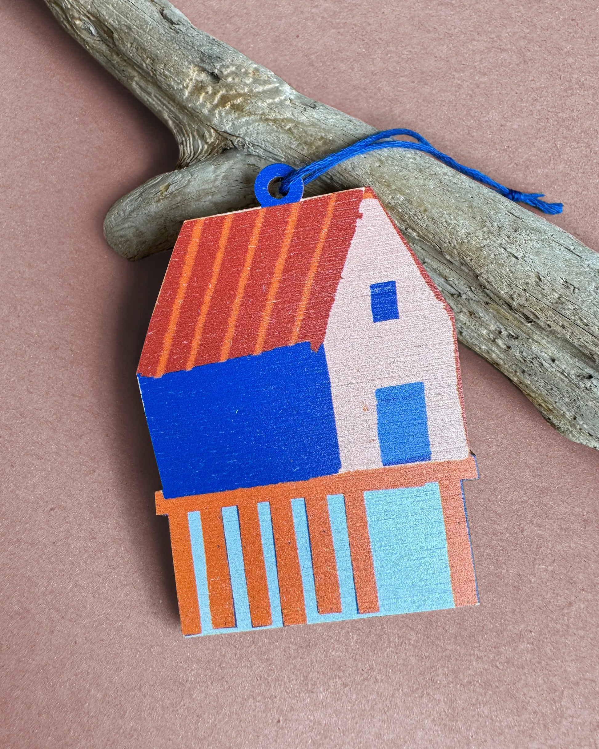 Colourful wooden fish shack ornament with a red roof and blue walls, designed by Kautzi in Cape Breton, Nova Scotia.