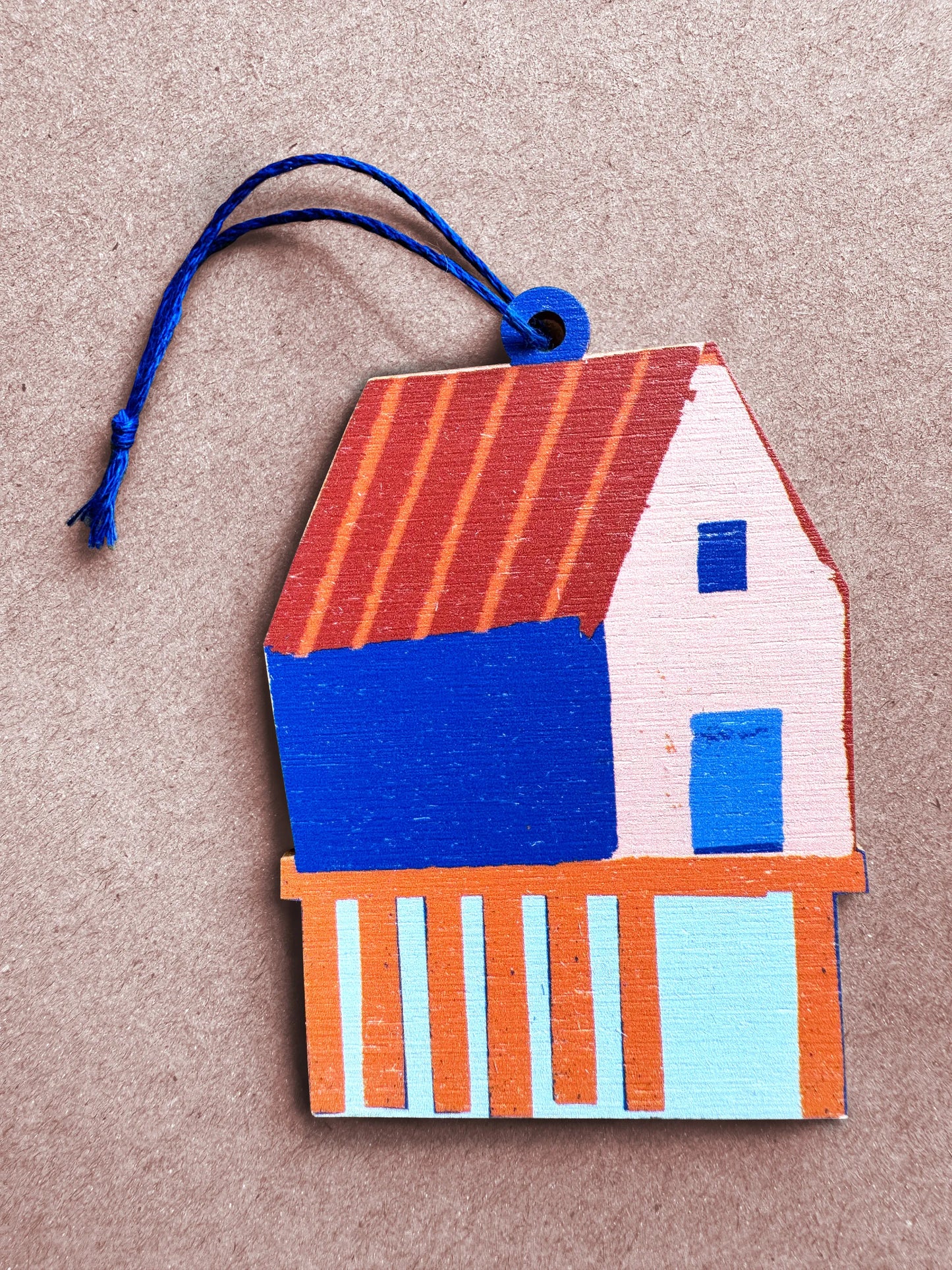 Flat lay of the fish shack wooden ornament, designed by Kautzi in Cape Breton, Nova Scotia.