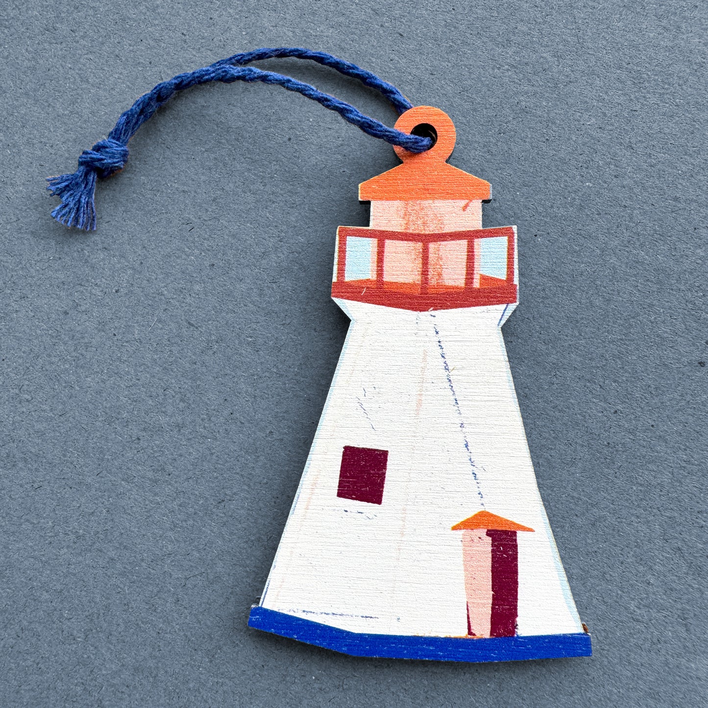 Kautzi wooden lighthouse ornament on grey background – illustrated Nova Scotia maritime lighthouse design with navy cord
