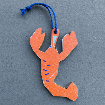 Kautzi wooden lobster ornament on grey background – bold orange Cape Breton, Nova Scotia coastal illustration with navy hanging cord